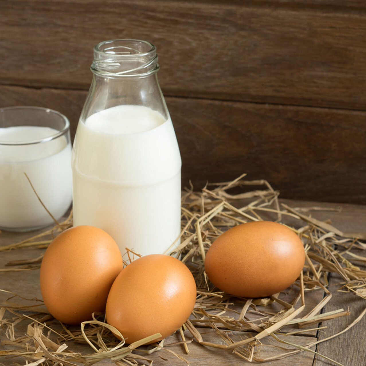 Chicken eggs with bottle and glass milk.